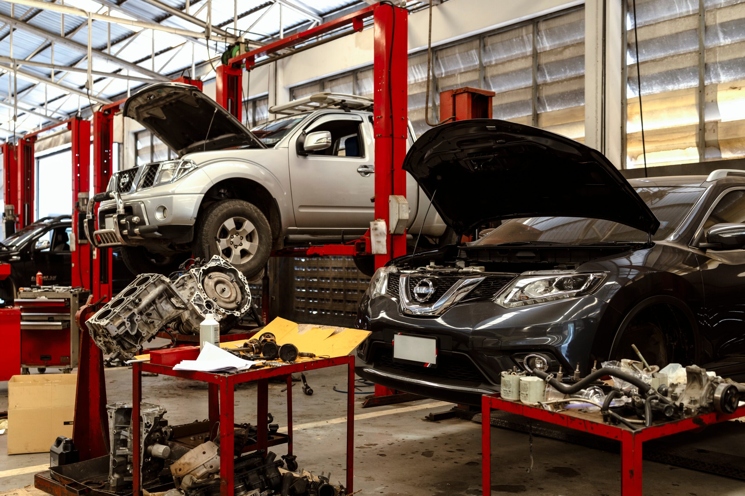 A,Busy,Car,Repair,Workshop,With,Multiple,Cars,On,Lifts